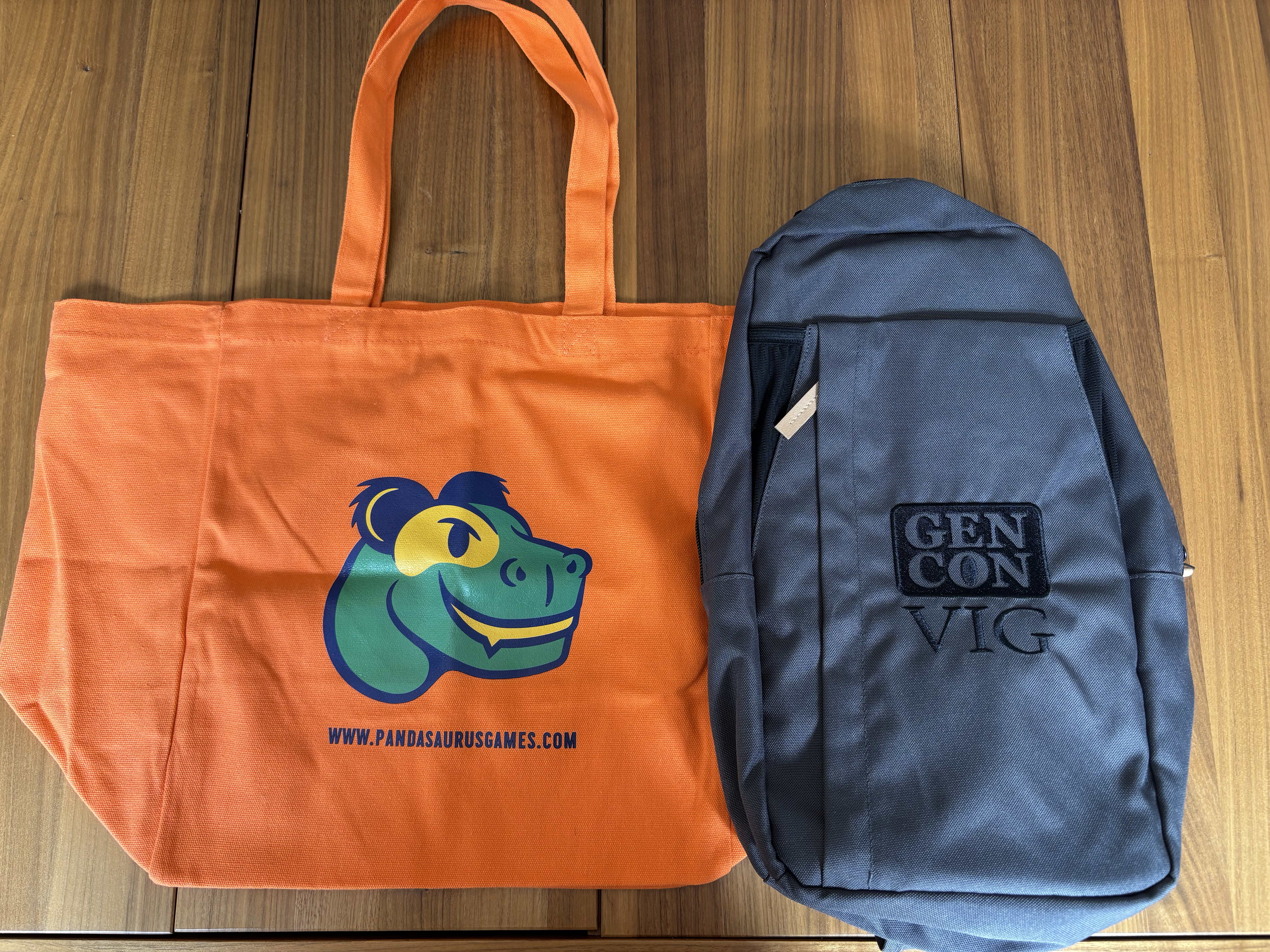My 2025 Gen Con bag haul, arrayed on my dining room table